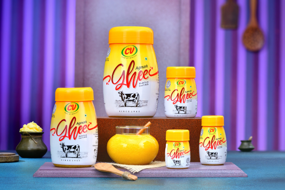 A table with several beautifully labeled jars of CV cow ghee from a ghee manufacturer in Coimbatore.