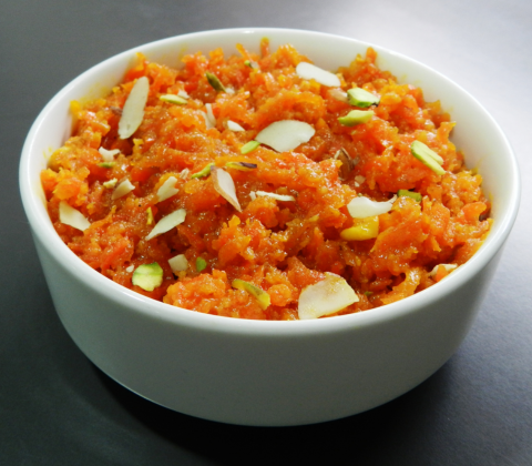 Carrots should be grated, cooked with milk, sugar, and ghee, topped with almonds, and served warm